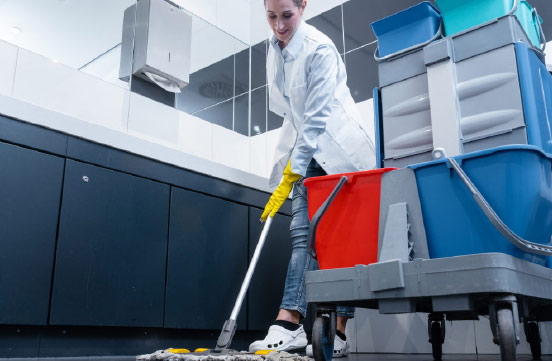 Janitor Cleaning Bathroom With Mop And Bucket