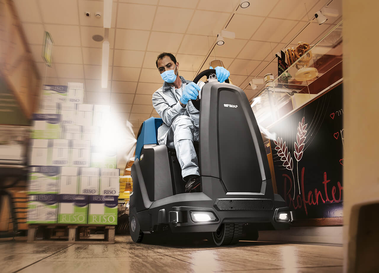 Man Cleaning A Restaurant Floor With A Floor Cleaning Machine
