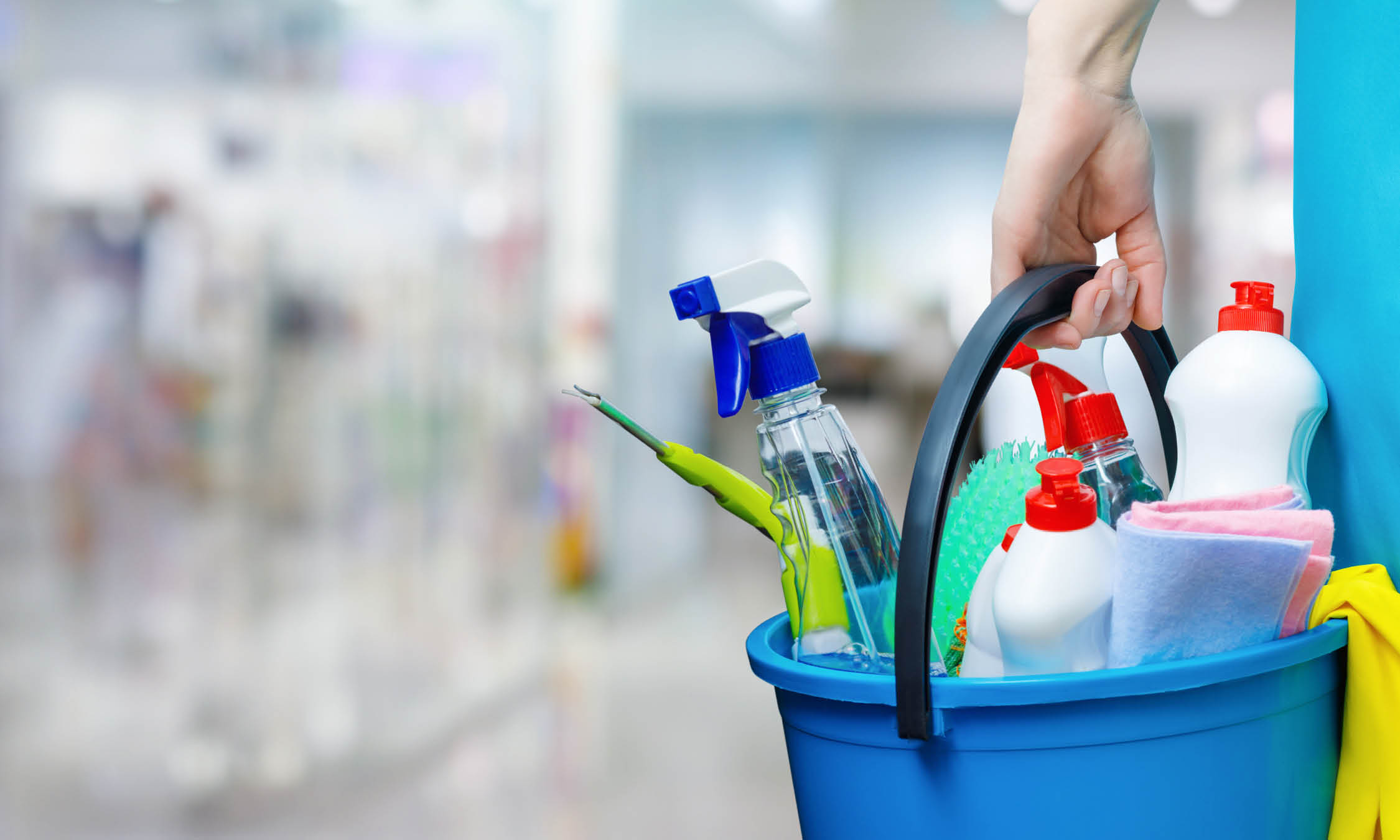 Person Carrying Bucket Of Janitorial Supplies