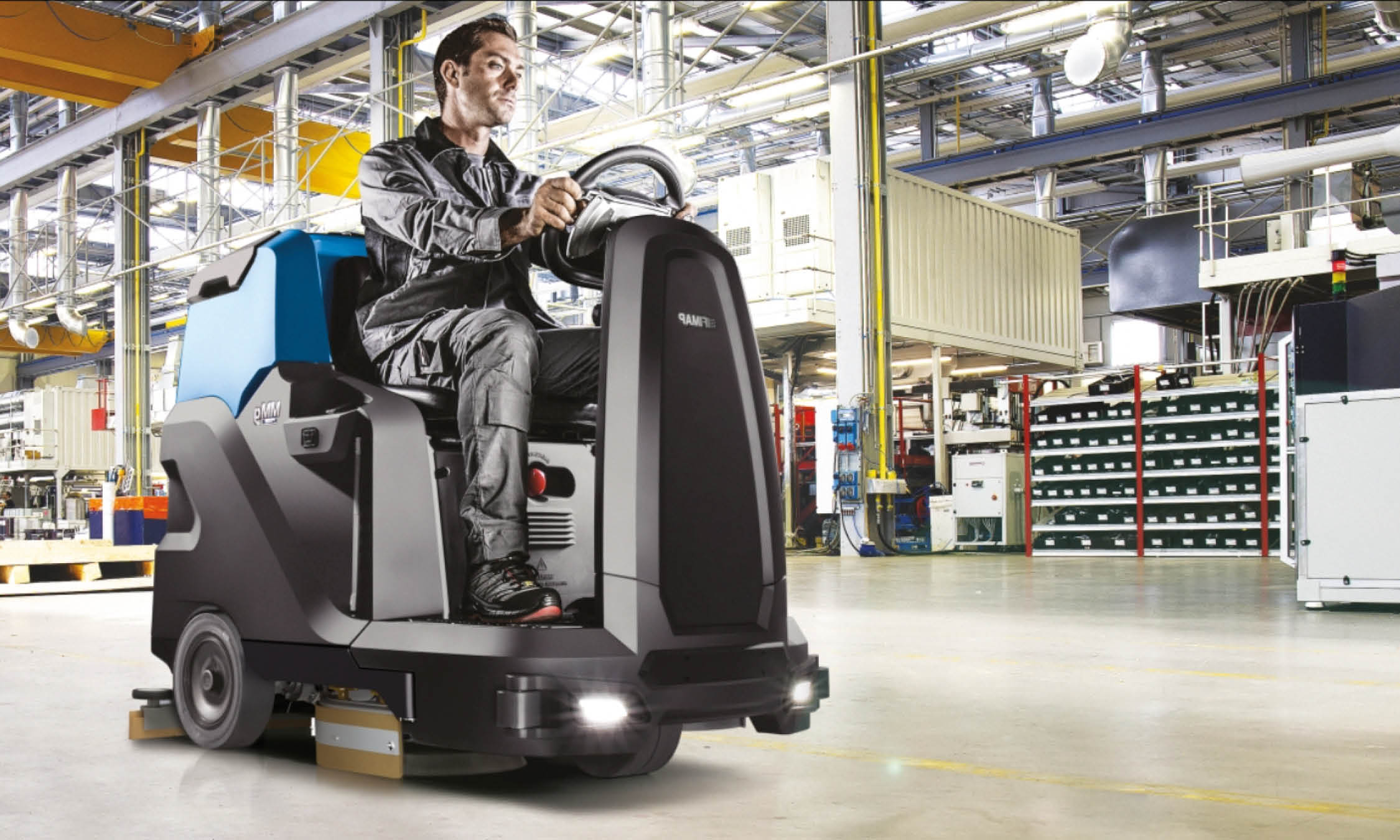 Man Using MMG Plus Floor Cleaning Machine To Clean Warehouse Floor
